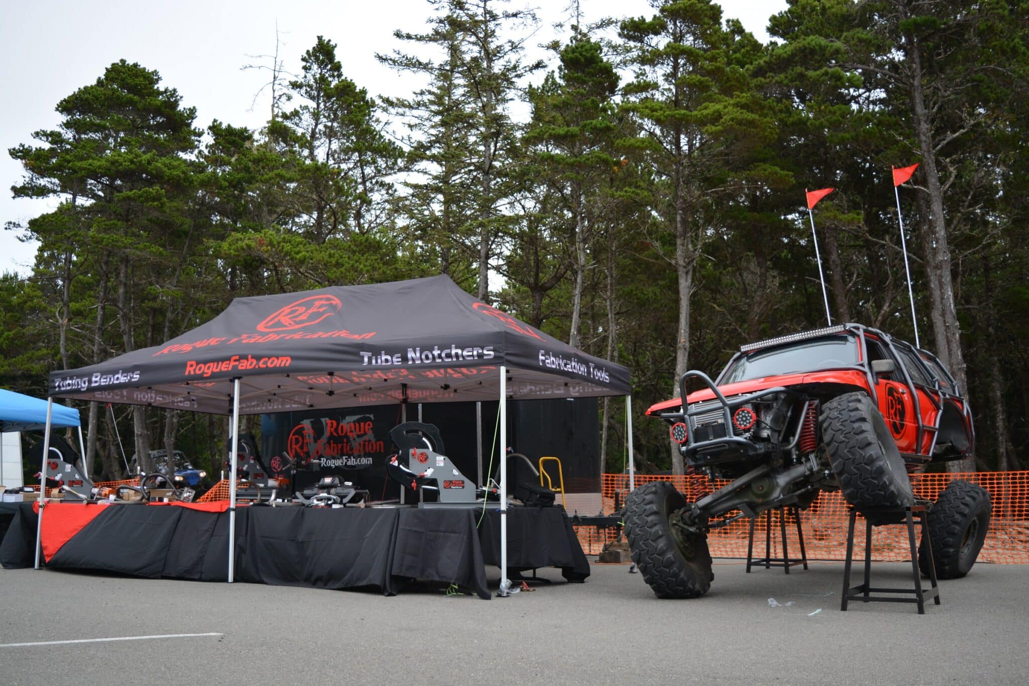 Rogue Fabrication vendor booth displaying tube benders and notchers with the Turbo Mogrunner Toyota 4Runner on display stands at an off-road event in Oregon