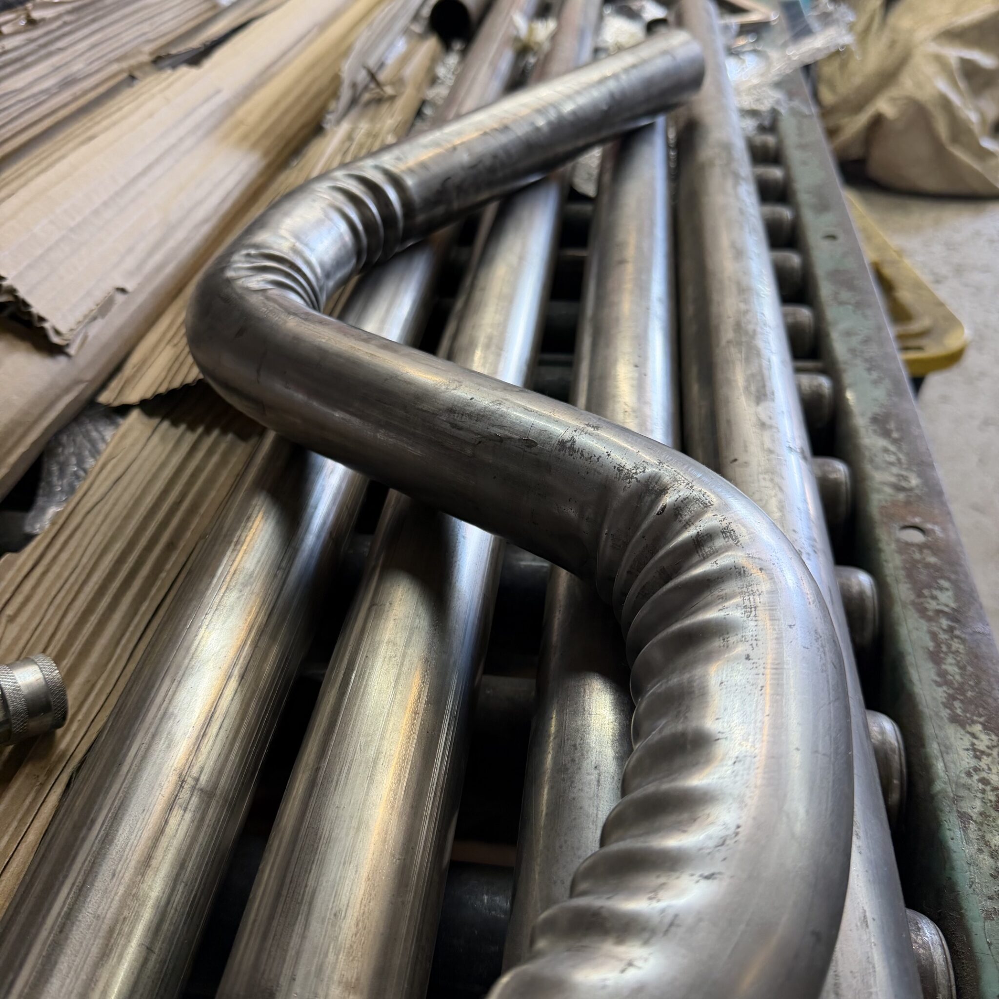 Wrinkled stainless steel tube bend showing wall ratio failure and inside wall buckling